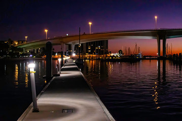 Fototapeta premium View of a harbor and bridge as the sun sets in Clearwater, Florida