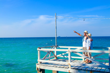 Asian elderly couple Travel after retirement Went to the sea very happy
