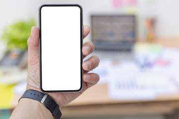 Mockup image blank white screen cell phone.man hand holding texting using mobile on desk at officebackground empty space for advertise text.people contact marketing business,technology 