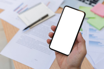 Mockup image blank white screen cell phone.man hand holding texting using mobile on desk at officebackground empty space for advertise text.people contact marketing business,technology 