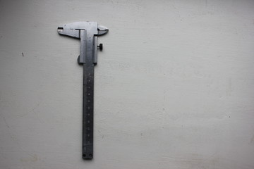 Closeup of measurement and markup tool on white wooden background