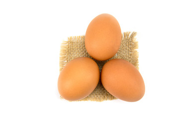 chicken egg isolated on sack cloth  and white background.
