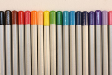 Row of colored pencils, background.