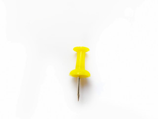 Yellow push pin isolated on white background