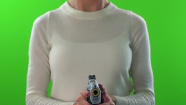 Female pointing gun forward, cocking and firing on green screen background