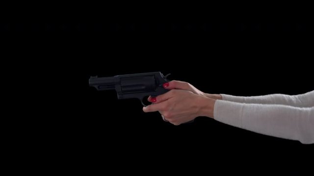 Female pointing gun, cocking and firing on black background