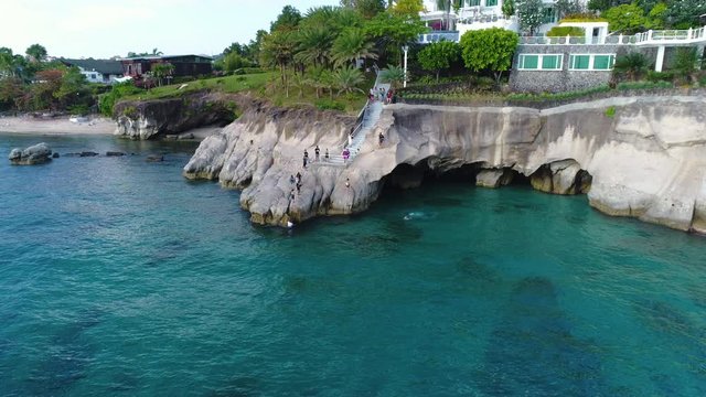 Aerial Shot Of Tourists Enjoying The Cliff On A Beach House In Tali Batangas