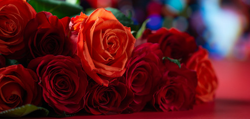 Fototapeta na wymiar Red roses with a red background, congratulations on Valentine's Day, happy birthday, or happy love day. Romance, Banner