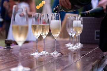 champagne wedding and champagne glasses put on wooden table