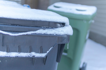 Garbage bins in winter covered in snow