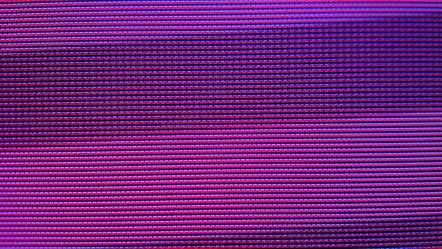 Close-up of the Monitor's Pixels. RGB pixels on the TV during the screening of the film, macro, close-up. Red, blue and green sub pixels create an image on the screen