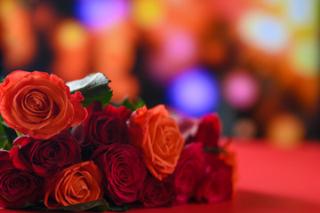 Festive bouquet with red roses on a colored background, congratulations on February 14, Valentine's Day. Love and romance