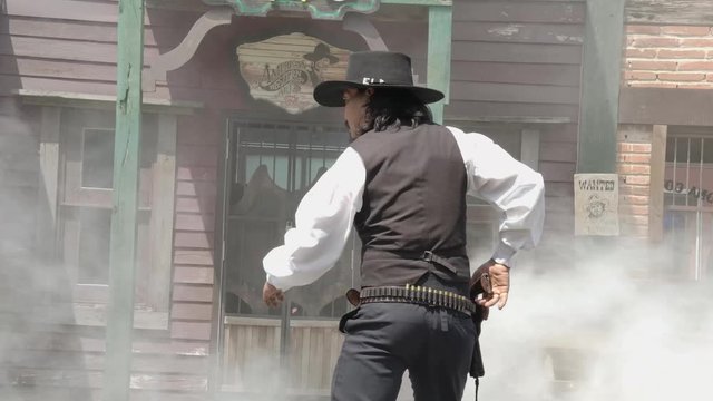 A sherriff ready to gun draw with the culprit infront of sheriff office.