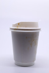 dirty brown stain on take away cup for hot coffee drink, paper mug on white background