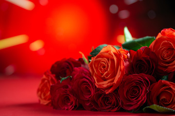 Fototapeta na wymiar Festive bouquet with red roses on a colored background, congratulations on February 14, Valentine's Day. Love and romance
