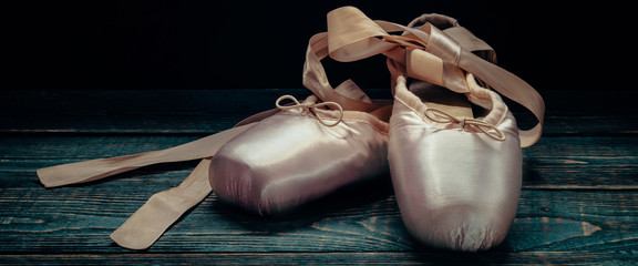 Pointes ballet shoes. Against a dark background.