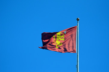 Flag with the Royal Coat of arms of the Norwegian Monarch on the roof of the palace. Oslo,Norway
