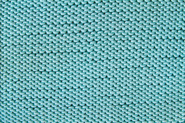 Turquoise knitted textured background. Closeup