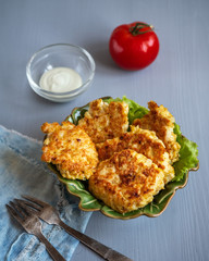 Light diet Breakfast of chicken cutlets and lettuce in a green ceramic salad bowl