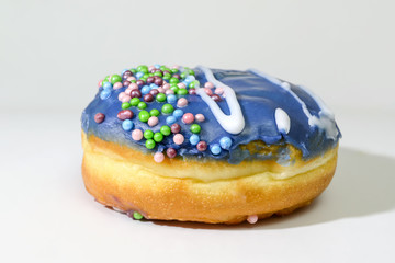 Blueberry donut. Multi-colored sprinkles on purple, blue glaze.