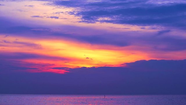 sunset purple on red cloud moving down on the sea and orange sky background