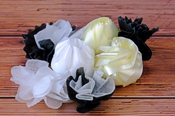 Coins in folded ribbons on wooden table to be given away in funeral.