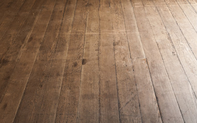 Wooden floor made of rough uncolored oak boards