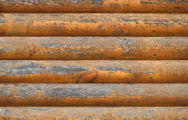 Wooden wall made of painted logs. Natural background texture
