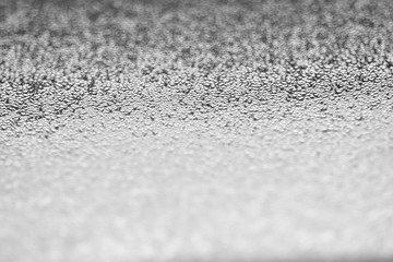 Condensated waterdrops on the windows glass. Greyscale