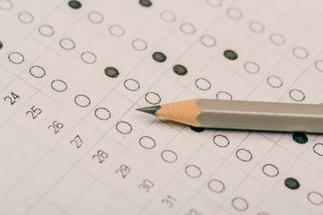 testing in exercise and exam paper. computer sheet with pencil in school test room, education concept