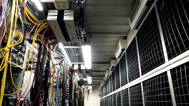 Inside Room With Data Centers And Cables. Stock Footage. Room With Data Centers, Cables And Solar Panels To Absorb Bright Artificial Lighting