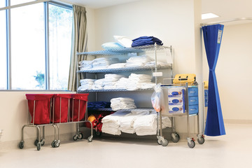 Hospital corner where linen is stocked on shelf.