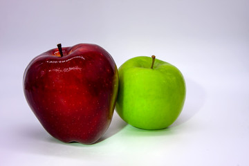 Green and dark red apple on a white background