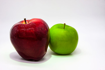 Green and dark red apple on a white background