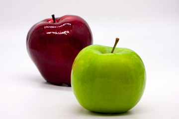 Green and dark red apple on a white background