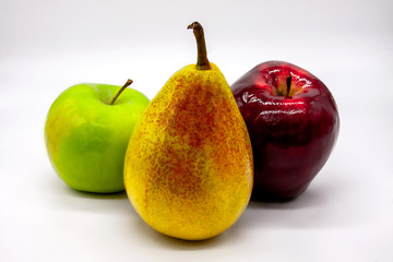 Three bright fruits: green and red apples and yellow-red pear