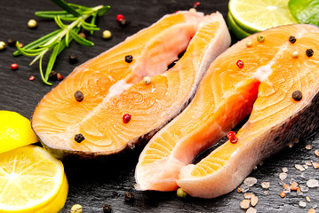 raw salmon steak on wooden board close up