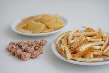 Candied orange peel, almonds and ginger on the white background