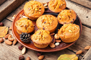 Nut muffins on wooden background
