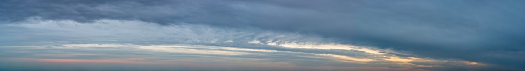 Fantastic clouds against blue sky, panorama