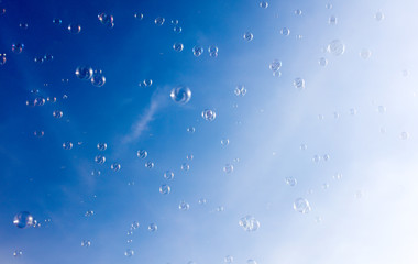 Soap bubbles fly in the blue sky