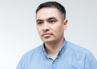 Fototapeta premium Attractive handsome smiling positive happy business man. Closeup portrait of a polite middle age man wearing a blue shirt