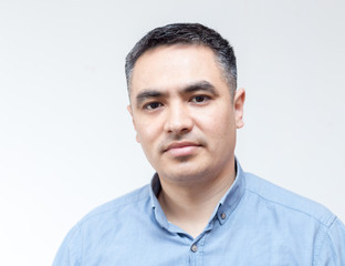 Fototapeta premium Attractive handsome smiling positive happy business man. Closeup portrait of a polite middle age man wearing a blue shirt