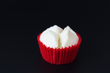 Colorful Thai steamed or Cotton wool cupcakes in red paper cup Thai dessert  on black background