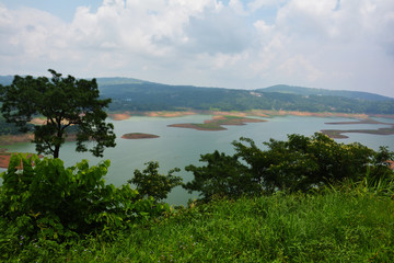 Fototapeta na wymiar Barapani or Umiam Lake of Shillong, Meghalaya as seen fron the view point on the road with water, trees and natural beauty, selective focusing