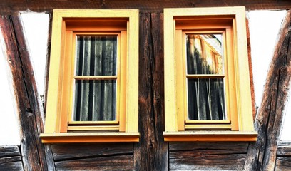 Close up of two windows of a timbered house