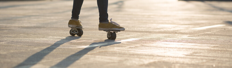 Freeline skateboarder legs skateboarding at city
