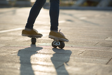 Freeline skateboarder legs skateboarding at city