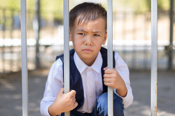 schoolboy holds cell and hopes for freedom or makes fun of the concept of life imprisonment