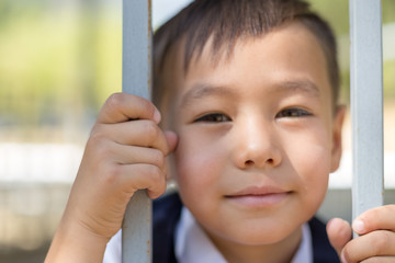 schoolboy holds cell and hopes for freedom or makes fun of the concept of life imprisonment